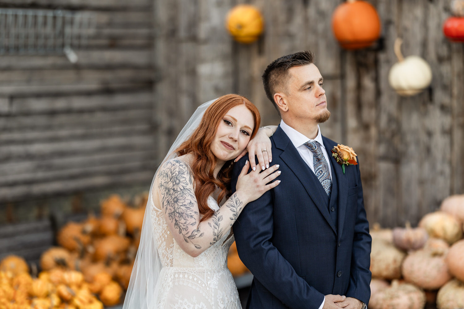 bride and groom at terrain at styers in front of pumpkins